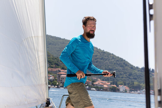 Sailor with underwater camera on yacht deck