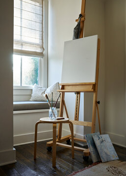 Tabula Rasa: Blank canvas on easel in home art studio