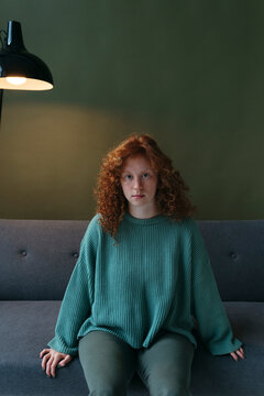 Red-haired female at home.