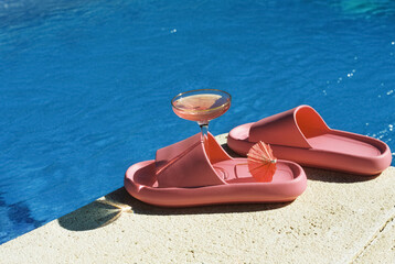 pink cocktail and pink sandals in the swimming pool, 35mm film
