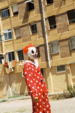 scary clown standing on the street, 35mm