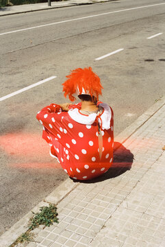 man wearing a clown mask and costume, 35mm