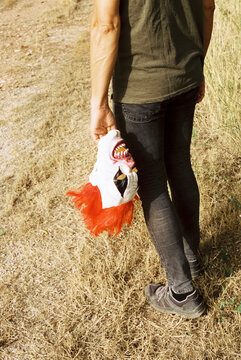 man with a clown mask in his hand, 35mm
