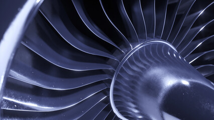 A large jet or airplane engine turbine with lot of silver blades.