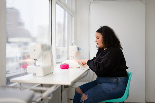 Fashion Designer Using A Sewing Machine