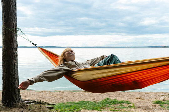 A woman is lying in a hammock