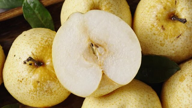 fresh Asian pear fruit and half sliced on wooden table.