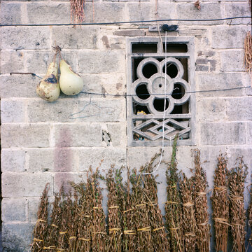 A wall with a Chinese style window
