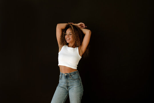 Portrait of happy woman against black background