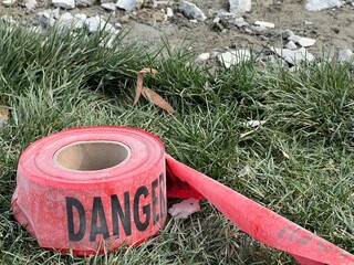 Red danger tape near a construction repair site - 753995169