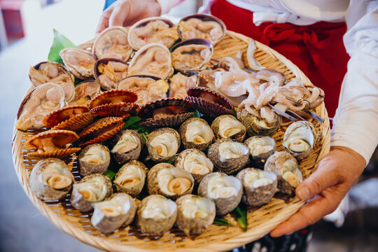 Assortment of shell seafood placed in a bamboo woven plate