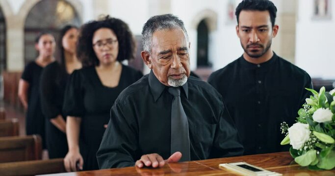Funeral, coffin and sad man at church for death and grief with people at burial ceremony with flowers. Memorial service, casket and senior person at chapel for mourning, goodbye and loss with family