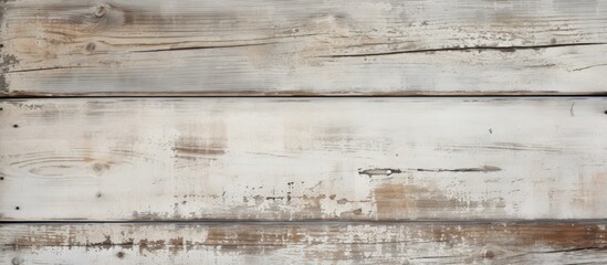 Close-up view of a wooden wall showing signs of weathering, with peeling white paint. The aged wood texture is visible, along with cracks and flaking paint, creating a rustic and worn appearance.