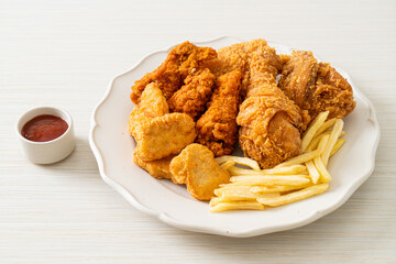 fried chicken with french fries and nuggets on plate