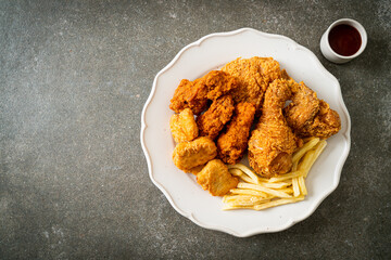 fried chicken with french fries and nuggets on plate
