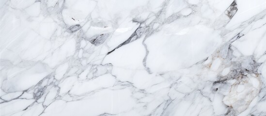 A detailed view of a smooth and elegant white marble texture, showcasing intricate patterns and veins characteristic of this luxurious material.