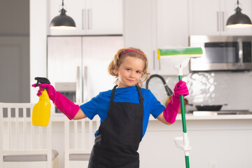Housekeeping, home chores. Little kid cleaning at home. Child doing housework having fun. Portrait...