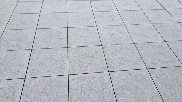 chess board made of small marble cubes. the gray and white mosaic in the square is a classic visual clich&eacute;. pavers work advertising spot. surface detail