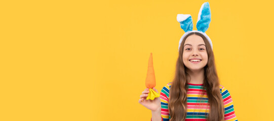 happy easter kid girl in rabbit bunny ears hold carrot for holiday. Easter child horizontal poster....