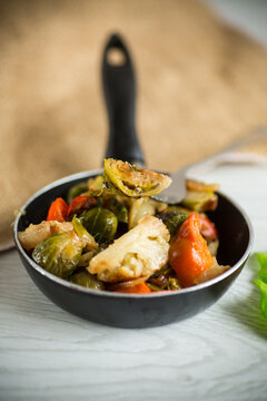 fried brussels sprouts with cauliflower and other vegetables in a frying pan