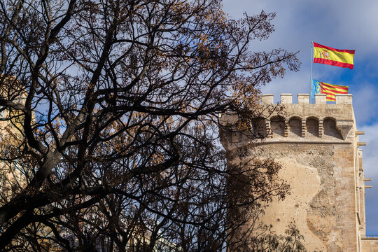 VALENCIA, SPAIN - March 8, 2024: Side View of the 15th Century Quart Towers (Towers of Quart) in Valencia with the Flags of Spain and Valencia on top. The Towers were built between 1441 and 1493.