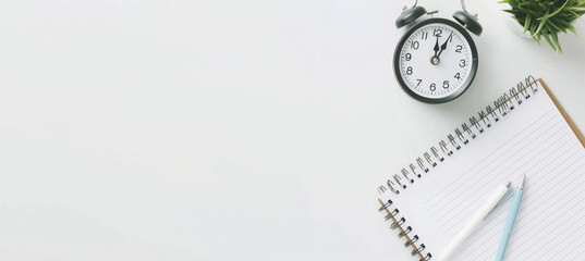 Time Management and Planning Concept - Desk with Clock, Notebook, Pen, and Plant