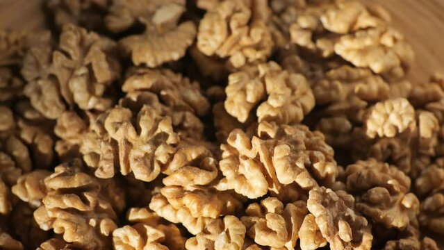 Walnut kernels rotating. walnut close up lies under beams of the sun. Walnut close up. product rich in minerals and vitamins. Macro 4K