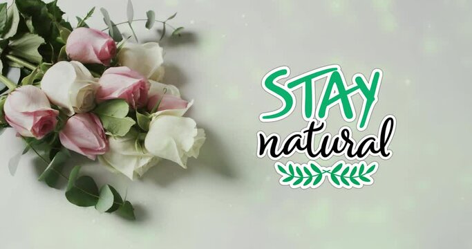 Animation of stay natural text over bunch of roses