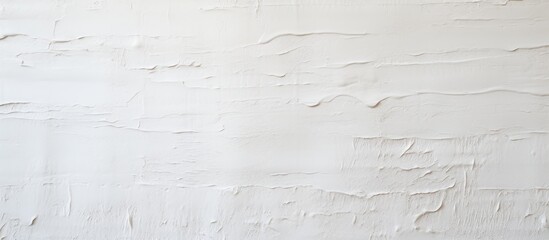 Obraz premium The white wall in this photo shows signs of wear and tear, with the paint peeling off in various spots. The texture of the peeling paint adds a layer of visual interest to the otherwise plain surface.