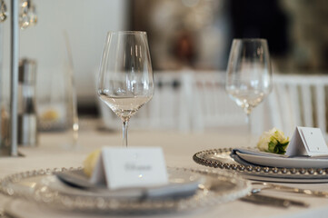 Cutlery and dishes on the table for guests at a wedding dinner in a restaurant