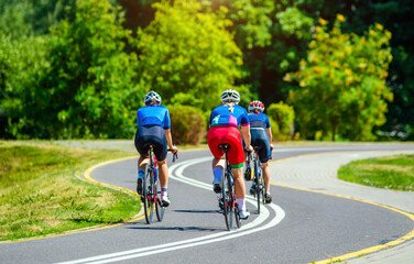 Cyclists ride on the bike path in the city Park
