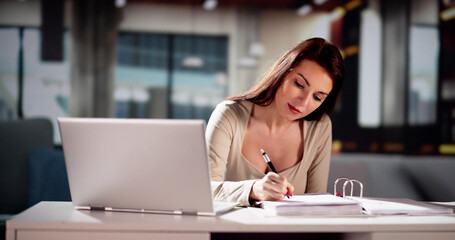 Fototapeta premium Women Calculating Finance Online On Couch