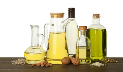 Vegetable fats. Different cooking oils and ingredients on wooden table against white background