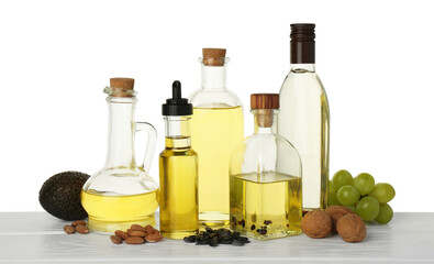 Vegetable fats. Different cooking oils and ingredients on wooden table against white background