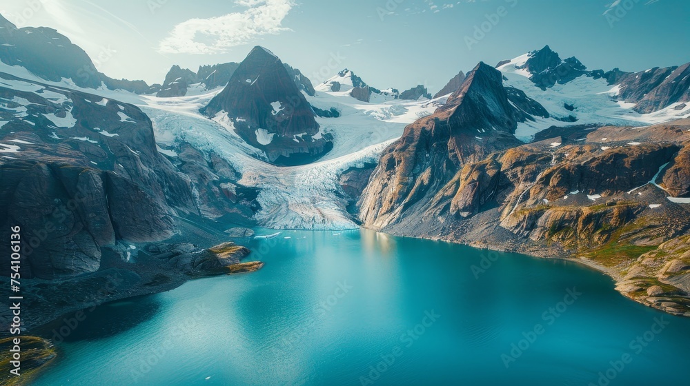 Wall mural A stunning aerial view of a glacier carving its path through mountains - Wall murals