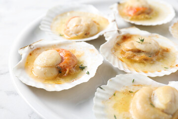 Fried scallops in shells on table, closeup