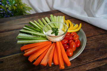 Mixed chopped fresh vegetables including carrots, tomatoes, Japanese cucumbers, broccoli, and bell...