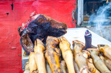 Lamb's chopped head in a street in front of temple use as food or for sacrifice in Mumbai, India - 754115174