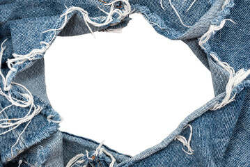 Hole in denim on a white background. Ripped jeans