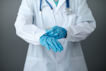 Doctor or nurse putting on sterile gloves. Close up concept. Virus. Testing covid 19. Ready for...