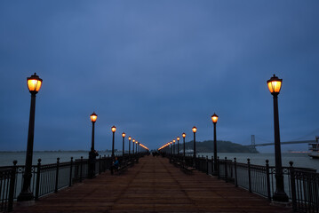 The Pier 7 in the Evening with San Francisco–Oakland Bay Bridge in the Background - California, USA