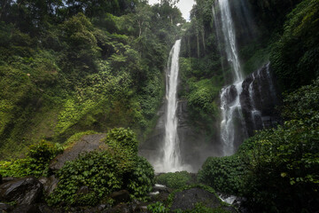 Fototapeta na wymiar Famous scenic Sekumpul waterfall flowing in the majestic alley of tropical forest of Buleleng province, Bali island, Indoneisa