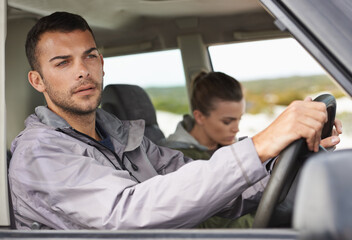 Couple, car and driving on roadtrip with travel for adventure, vacation and concentration of driver...