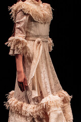 Children's beige long vintage dress with ruffles and belt. Elegant fashion for girls