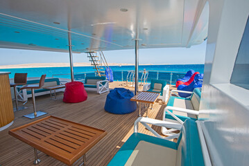Table and chairs on stern sun deck of a luxury motor yacht