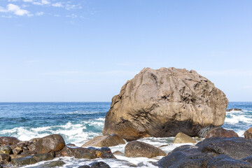 Fototapeta na wymiar Rock and waves with blue ocean horizon in Gran Canaria, Spain