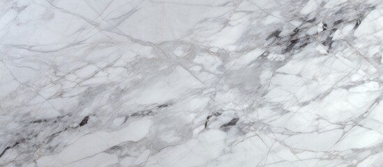 Detailed view of a white marble surface, showcasing intricate natural patterns and textures of the stone. The close-up shot captures the smooth and polished appearance of the marble,
