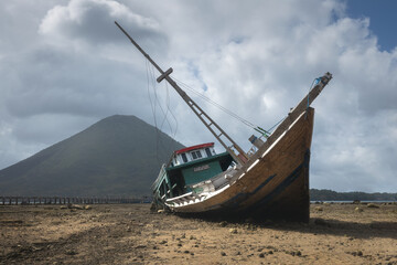 Shipwreck at low tide at the coast of Banda islands in Maluku district in Indonesia