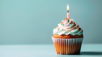Delicious birthday cupcake with candle on light blue background. Space for text .