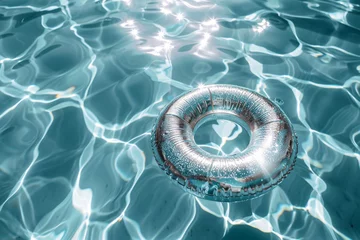 Fotobehang A sparkling pool ring floating in the water, creating a sense of relaxation and leisure © BeblackDesign